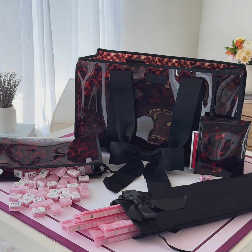 Woman setting up her Mahjong set using her Tortoiseshell Bow Mahjong tote set 
#color_tortoiseshell bow
