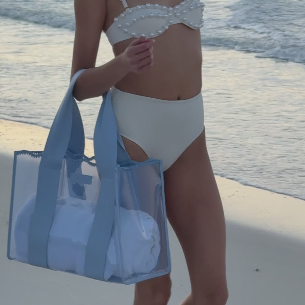 A Woman on the beach showing her Carolina Blue Crotchet Jelly Tote bag
#color_carolina blue crochet wave