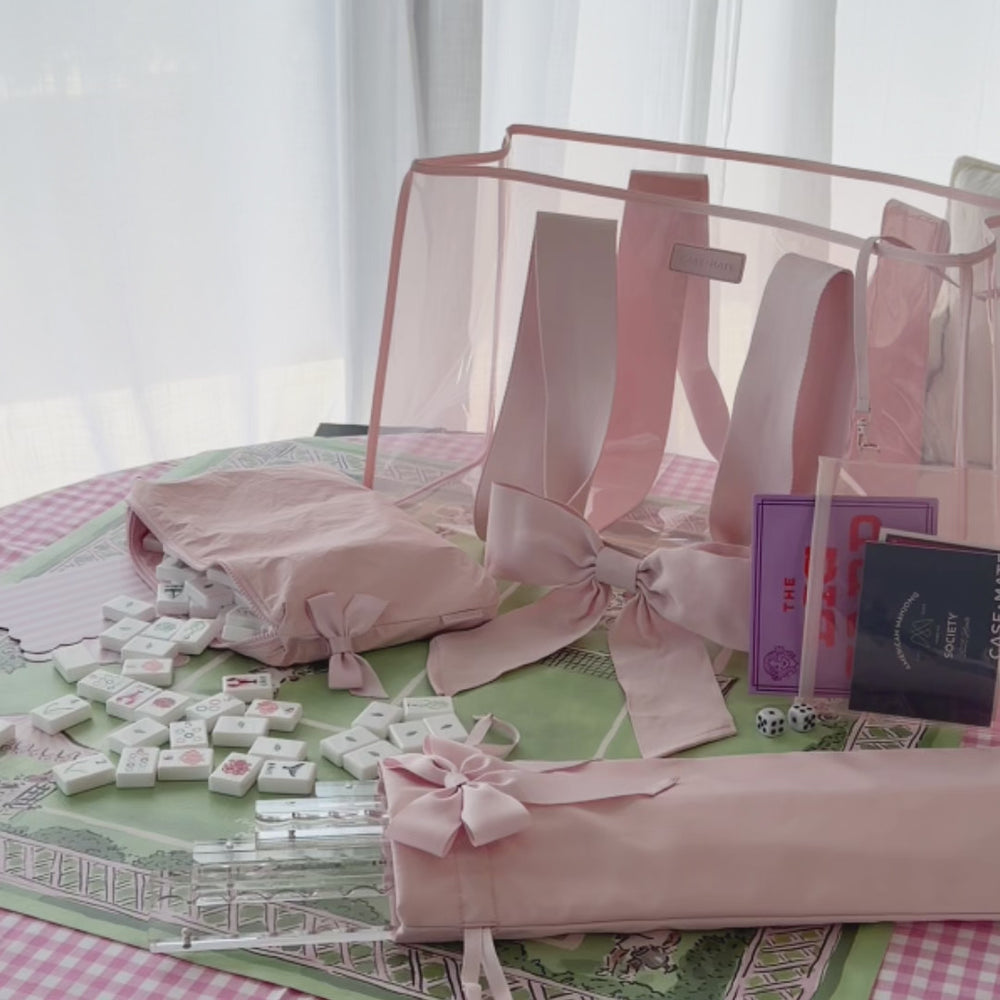 Woman unpacking her Mahjong Tote Set to set up a match #color_ballet pink bow