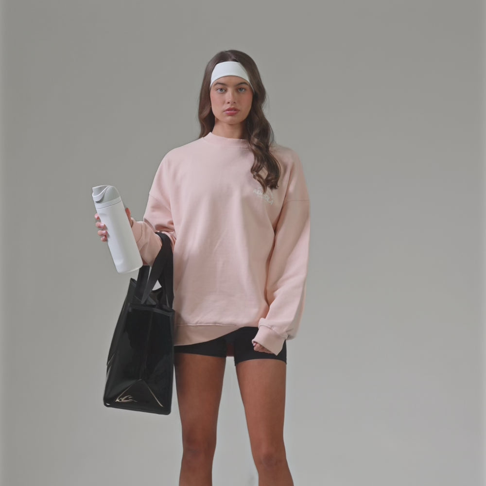 A woman showing off her Midnight Black Jelly Tote with a water bottle
#color_midnight black