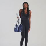 A woman showing off her medium jelly tote
#color_something navy twilly 