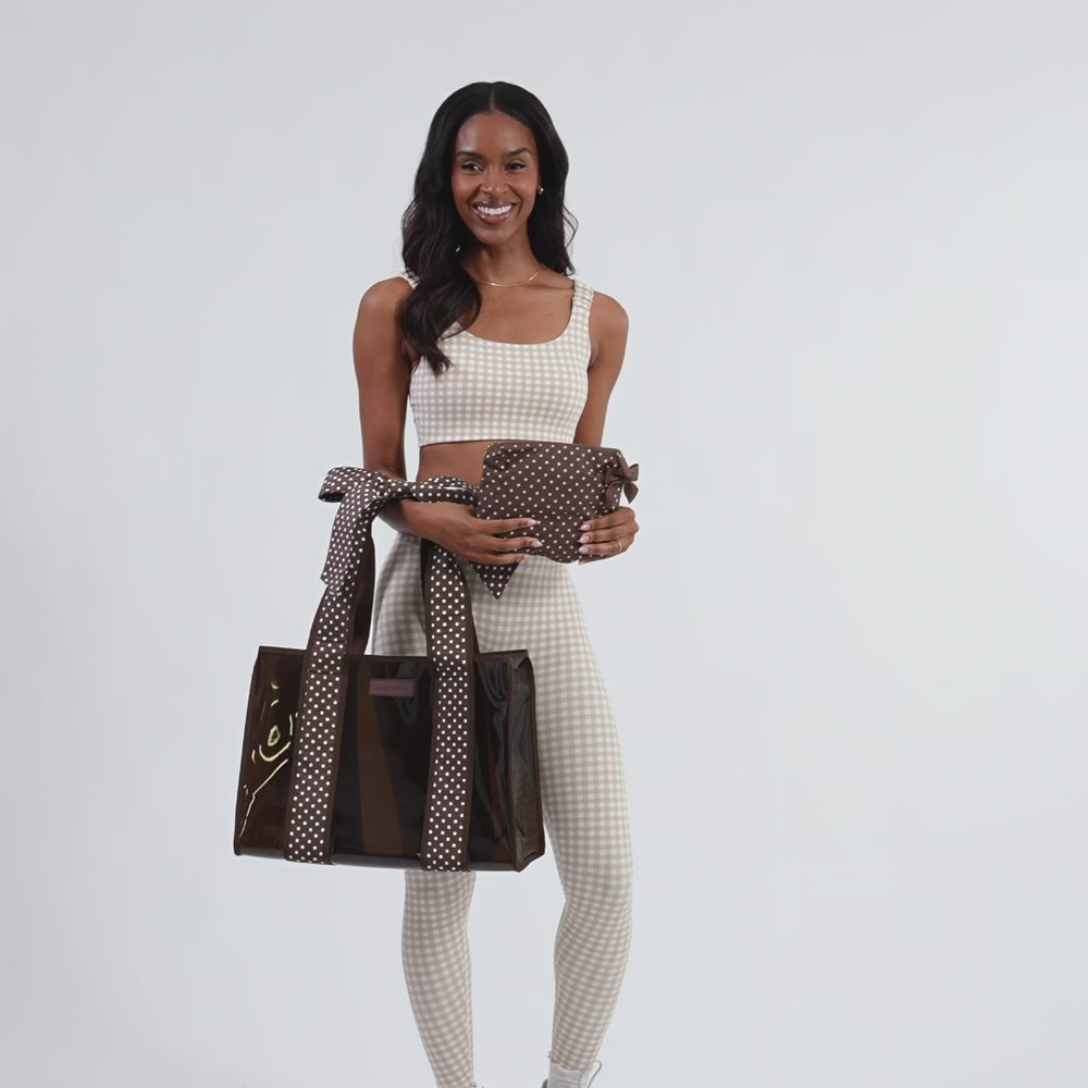 Woman showcasing Espresso Polka Dot Bow Jelly Tote + Crinkle Bag #color_espresso polka dot bow