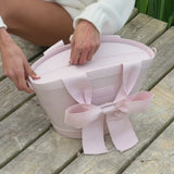 Two women by the lake with their pink cooler totes