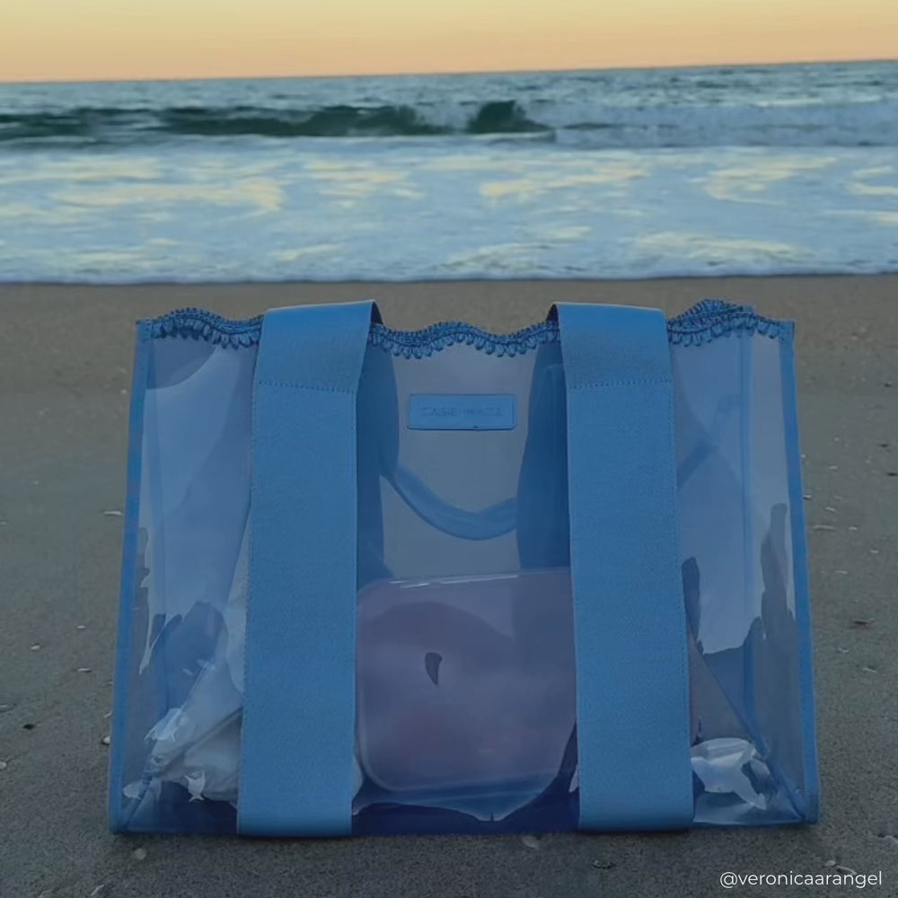 A woman on the beach showing her Carolina Blue Crotchet Jelly Tote Bag 
#color_carolina blue crochet wave