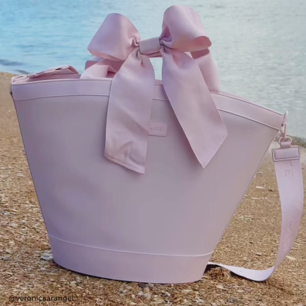 Girl by the water with Ballet Pink Bow Cooler on her shoulder #color_ballet pink bow