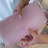 Video showing someone squish the Jelly Makeup Bag and then packing it with cosmetic items

#color_ballet pink twinkle