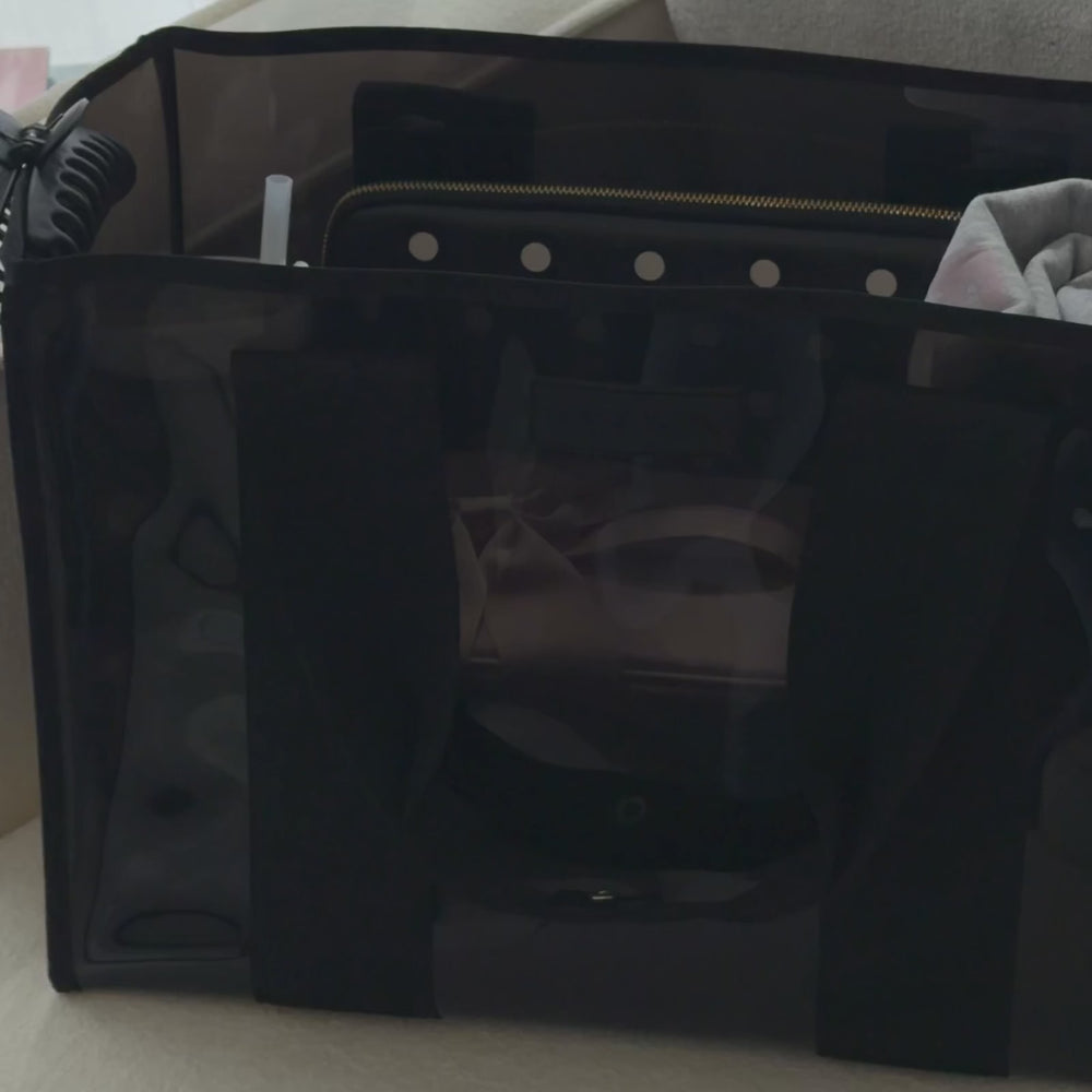 Woman packing a midnight jelly tote bag to show what all can fit in it
#color_midnight black