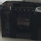Woman packing a midnight jelly tote bag to show what all can fit in it
#color_midnight black