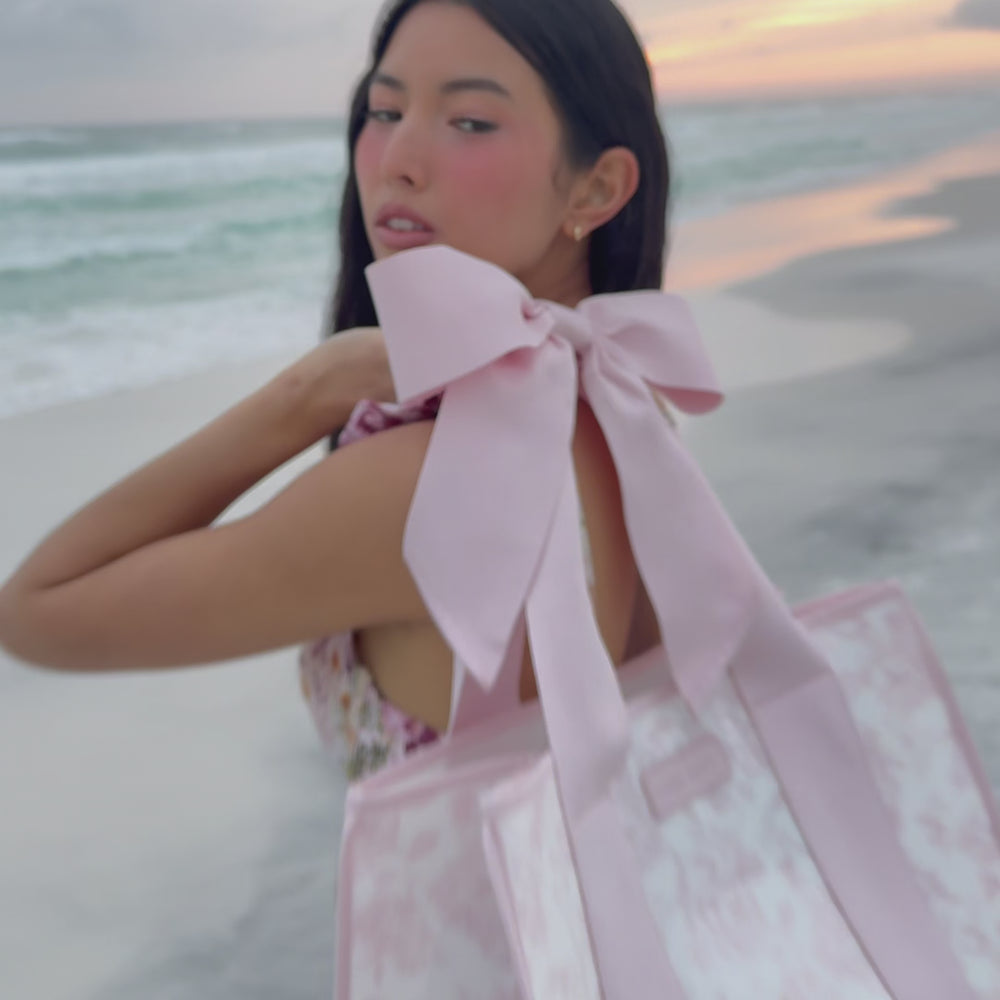 a woman at the beach showing her jelly tote