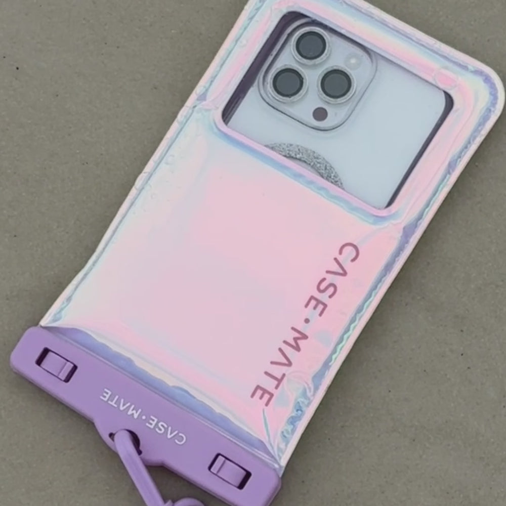 A woman at the beach showing her floating waterproof phone pouch