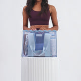 A woman packing her Carolina Crotchet Wave Jelly Tote full of her accessories
#color_carolina blue crochet wave
