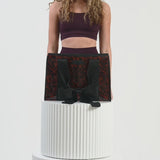 Woman packing tote bag with various items #color_tortoiseshell bow