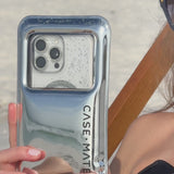 A woman using the waterproof floating pouch at the beach #color_silver chrome