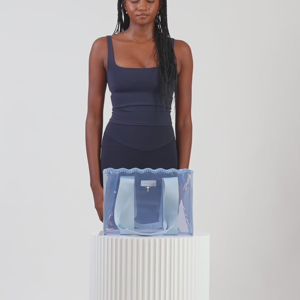A woman showing off her medium jelly tote
#color_carolina blue crochet wave