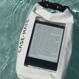 A woman using a kindle in a sand dollar bucket bag in a pool #color_sand dollar