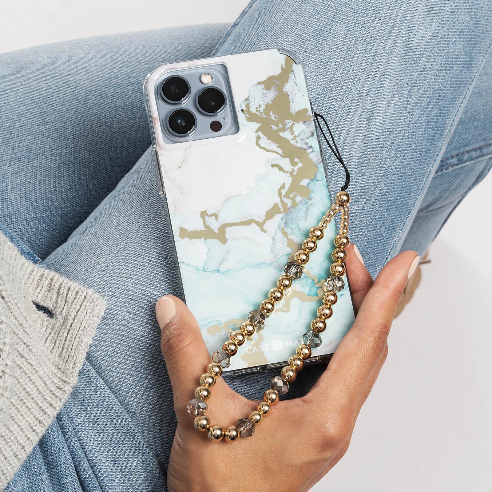 Ocean Marble case on iPhone 13 Pro with gold phone charm. color::Ocean Marble