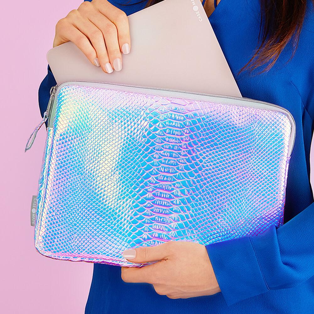 Woman pulling laptop out of Iridescent Snake laptop sleeve. color::Iridescent