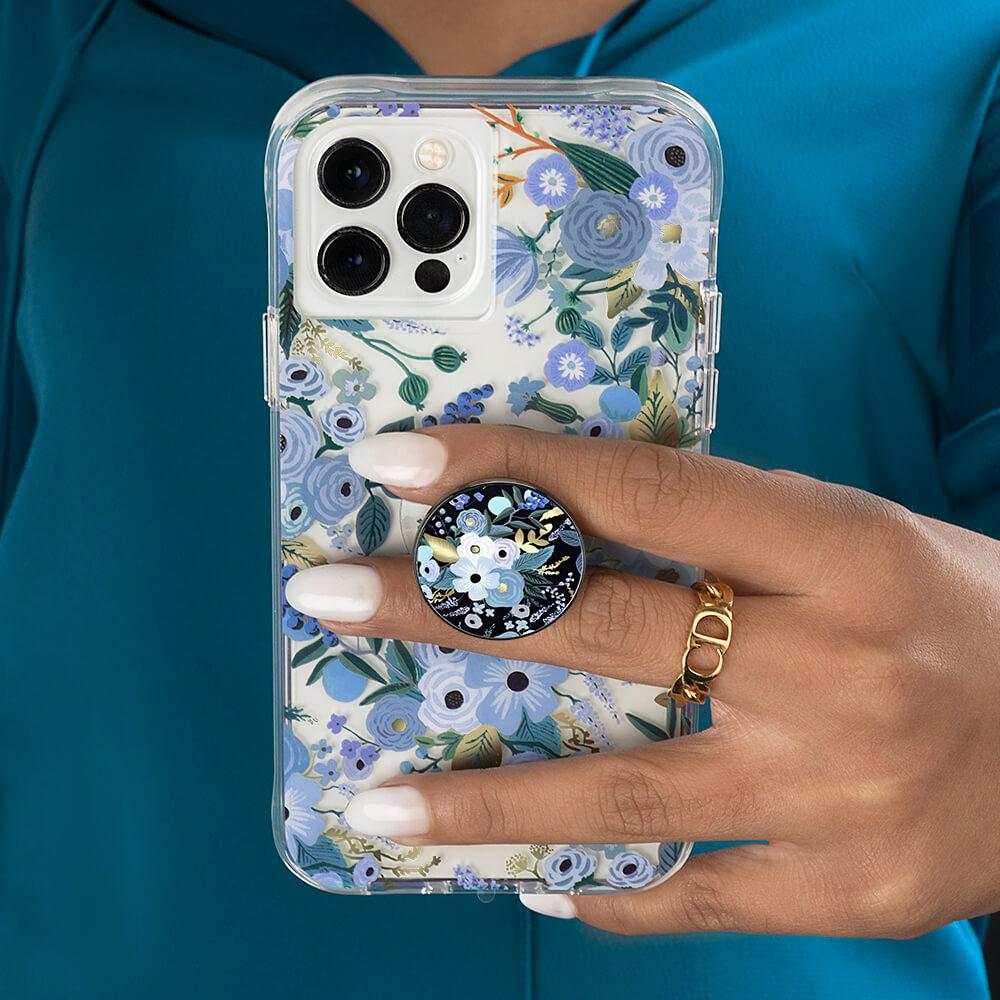 Hand holding Garden Party Blue case and mini combo. color::Garden Party Blue