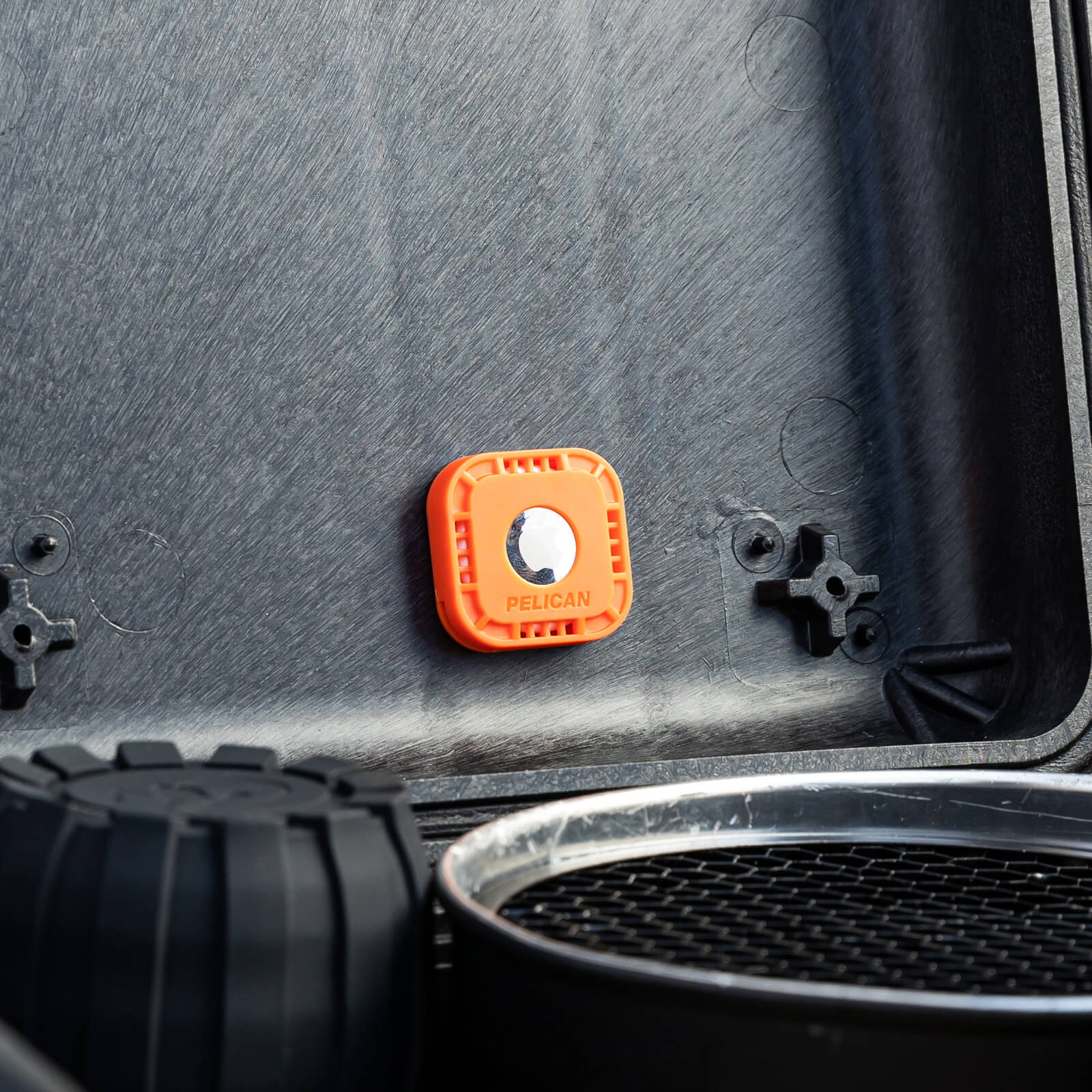 Airtag sticker mount stuck inside a gear bag. color::Orange