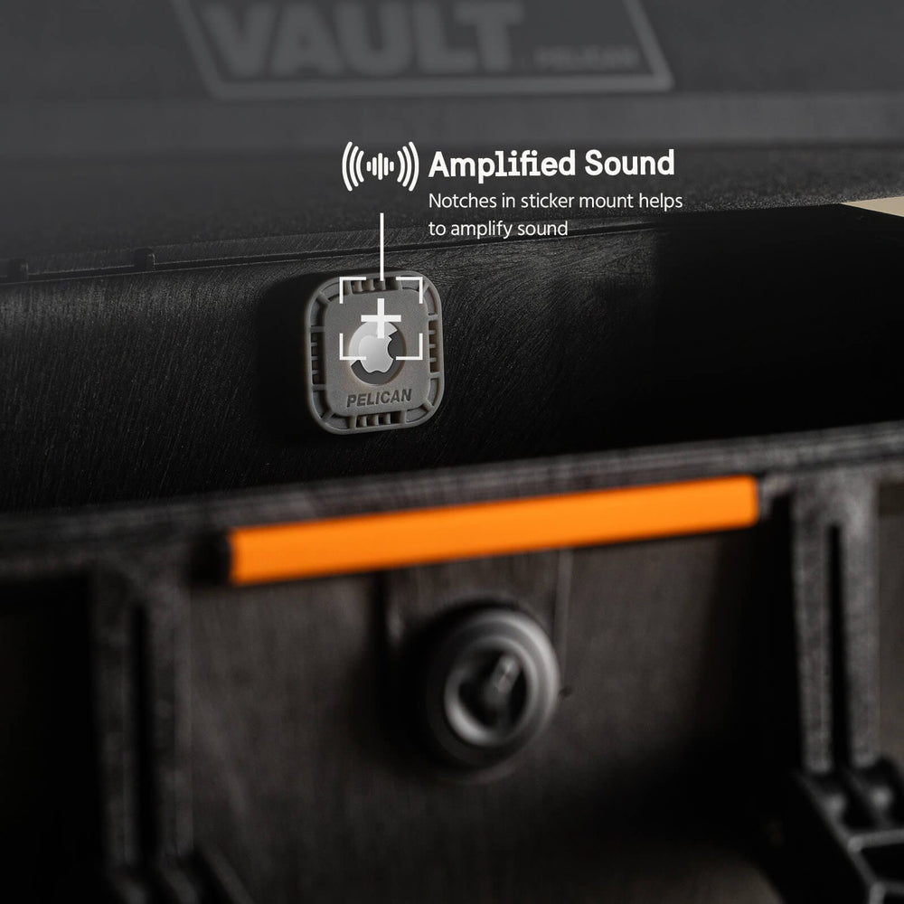 Grey Pelican AirTag sticker mount with notched design attached to black case with orange accent stripe.