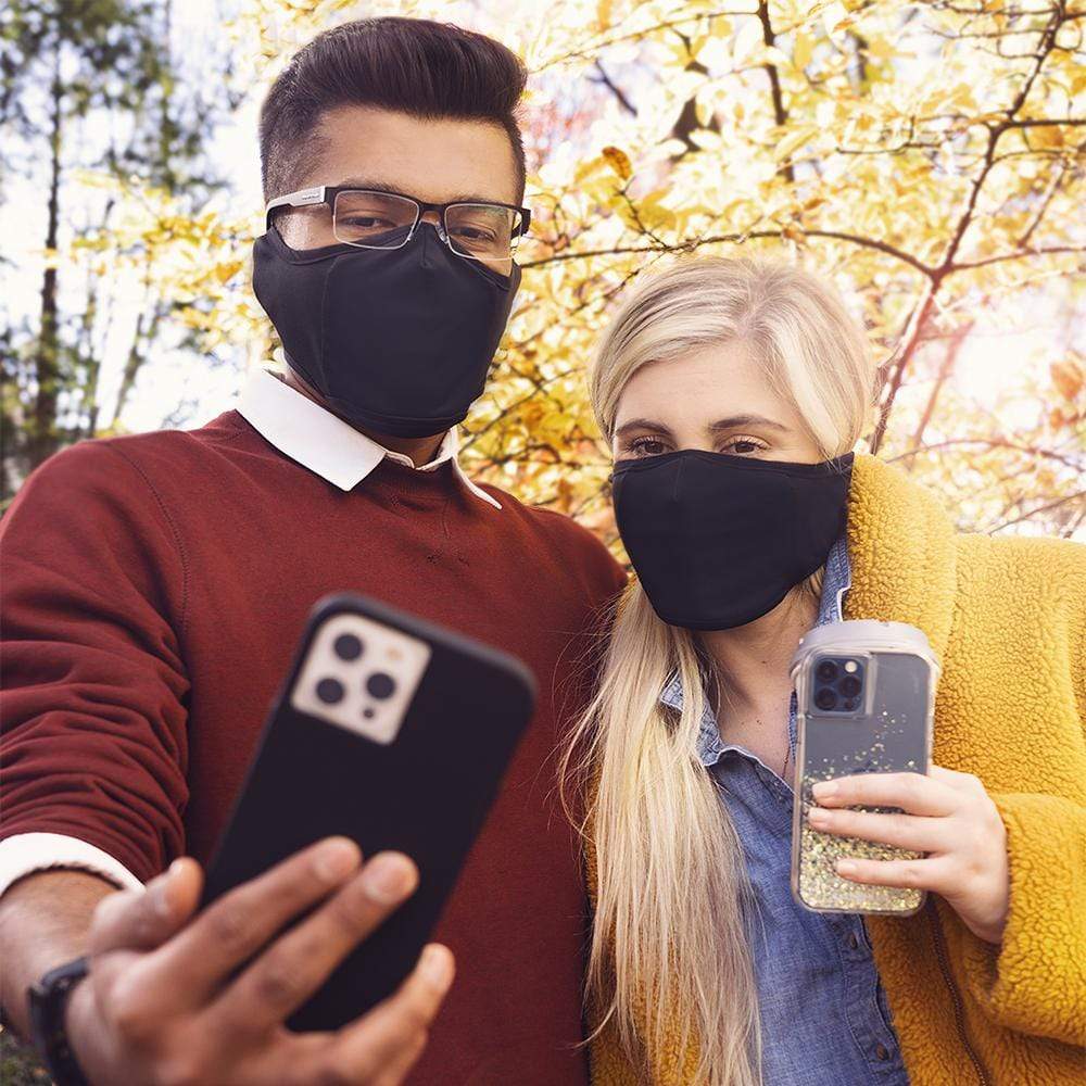 Man and woman wearing winter cloth masks in cold weather. color::Black