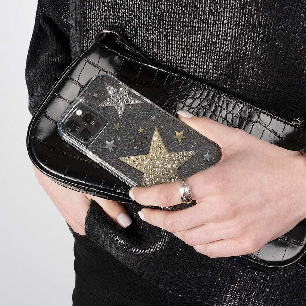 Hand holding sheer Superstar against black purse. color::Sheer Superstar