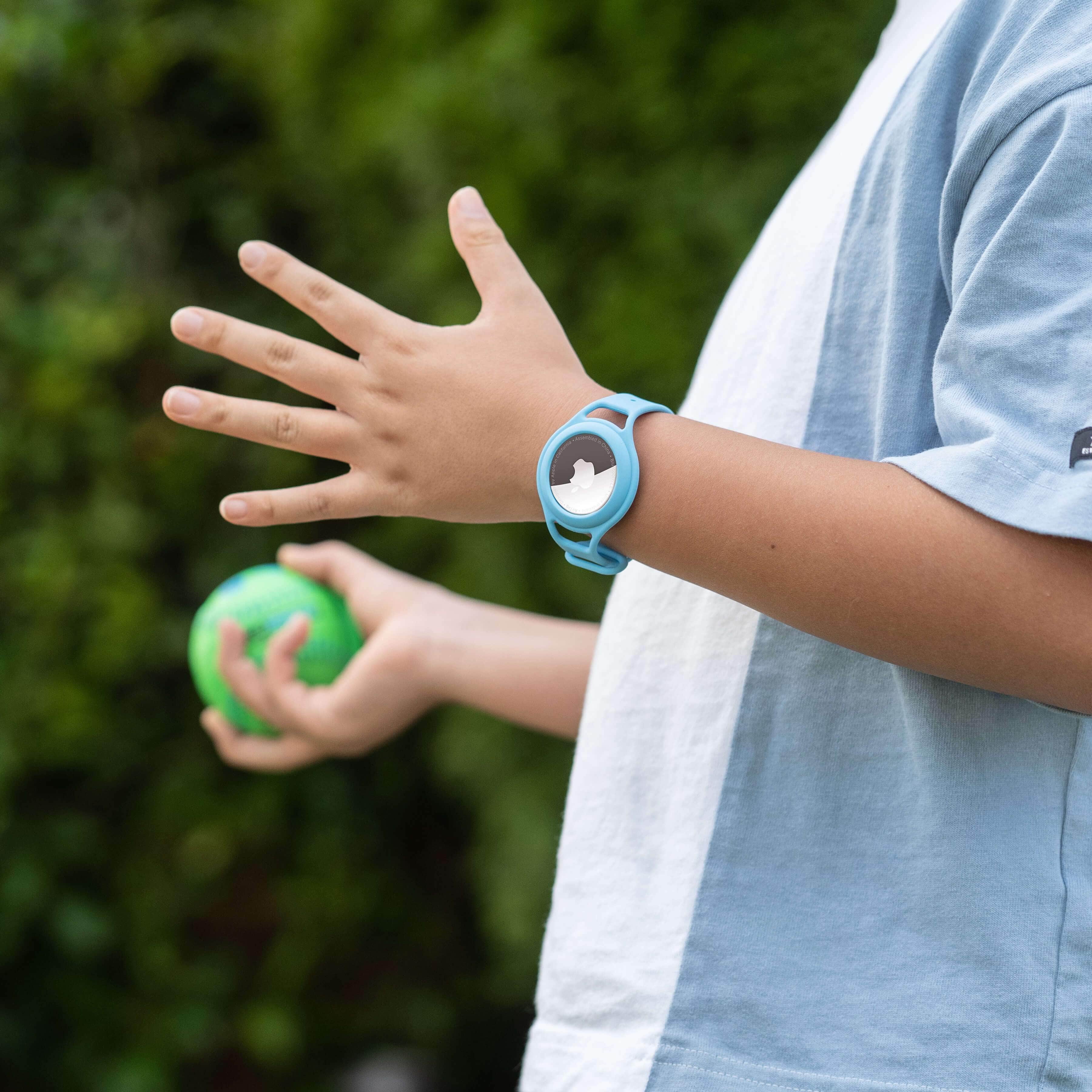 Kid wearing AirTag Tracker Strap while playing ball. color::Blue