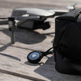 Pelican Protector AirTag Case clipped onto a backpack. color::Black