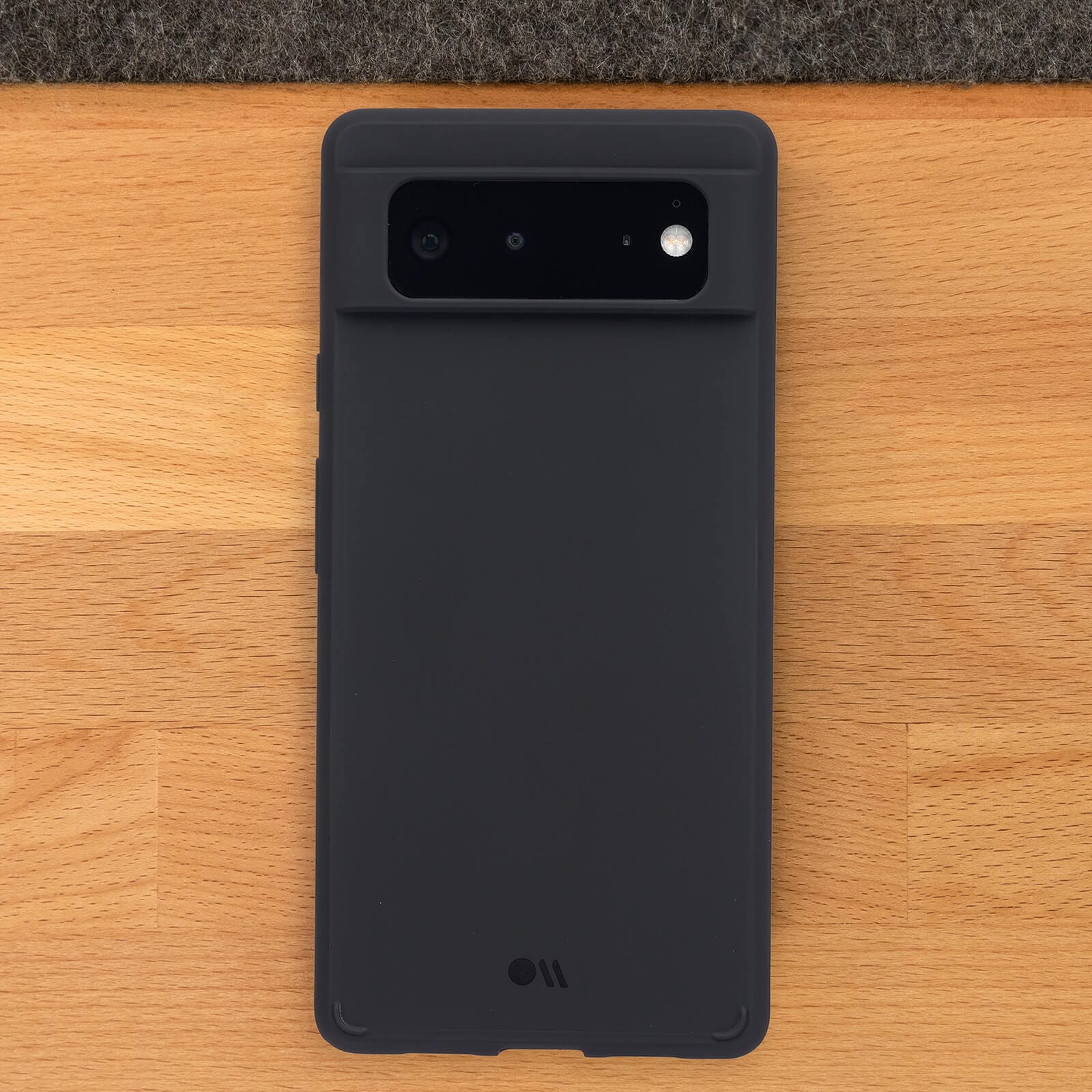 Tough Black Pixel 6 Case on a wooden background. color::Black
