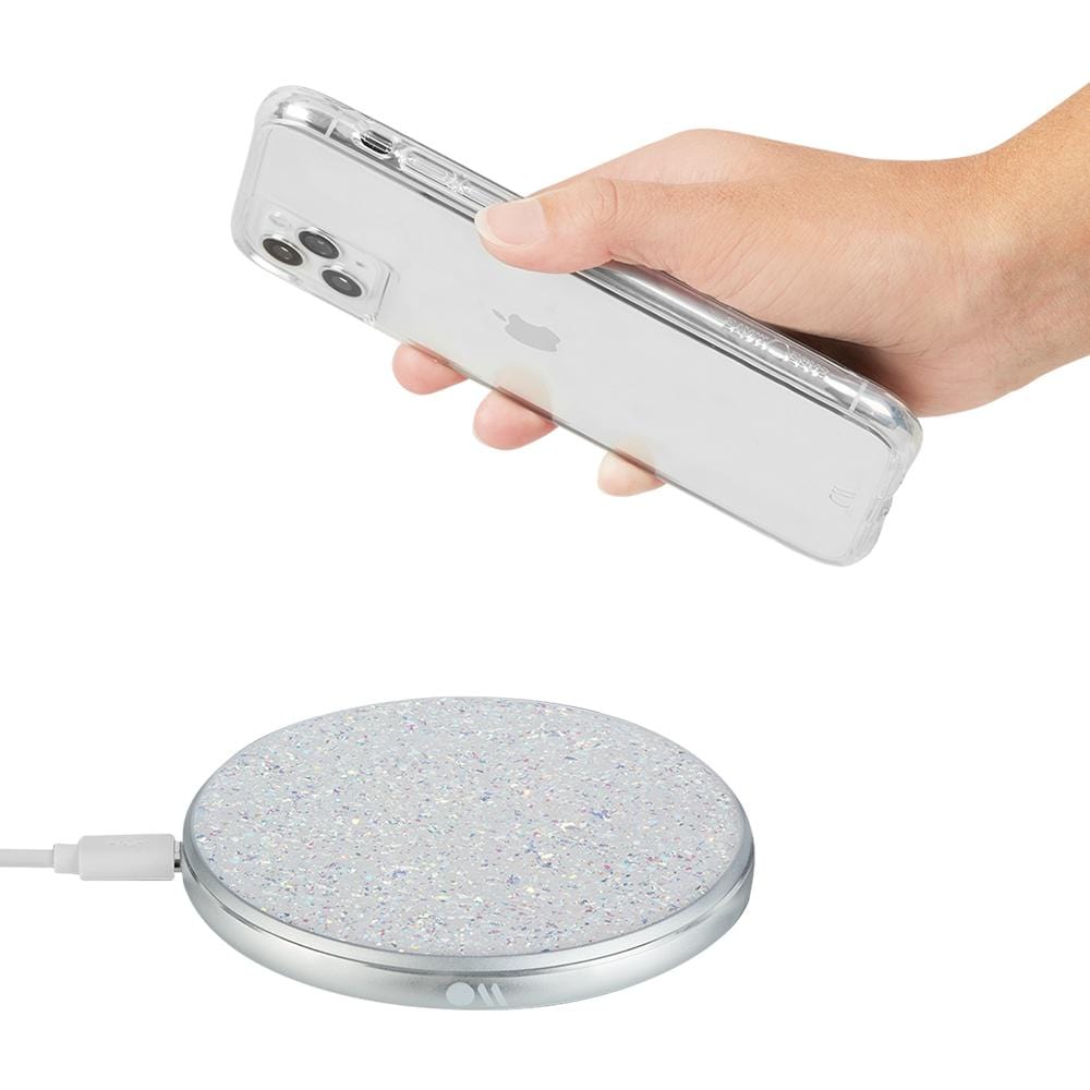 Hand placing phone on power disc. color::Twinkle Stardust