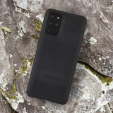 Black Pelican Protector sitting on a rock. color::Black