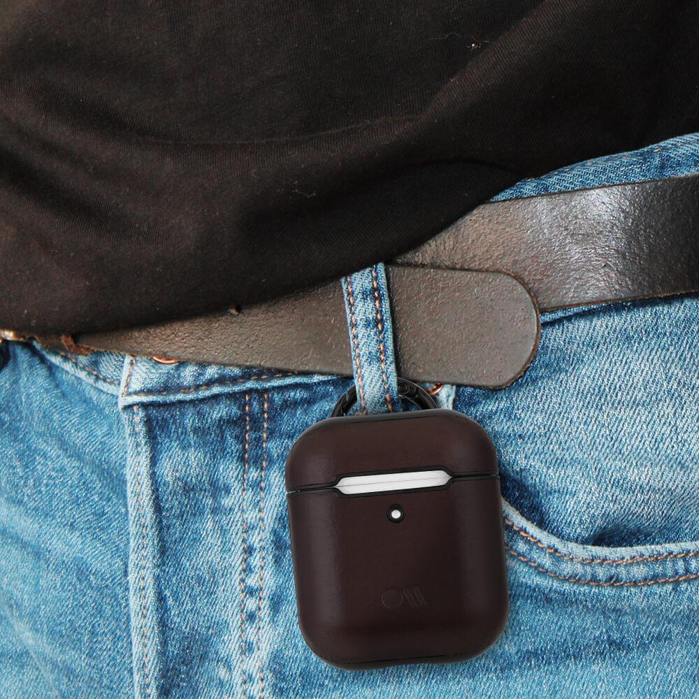 Brown Leather AirPods case hooked on belt loop. color::Brown