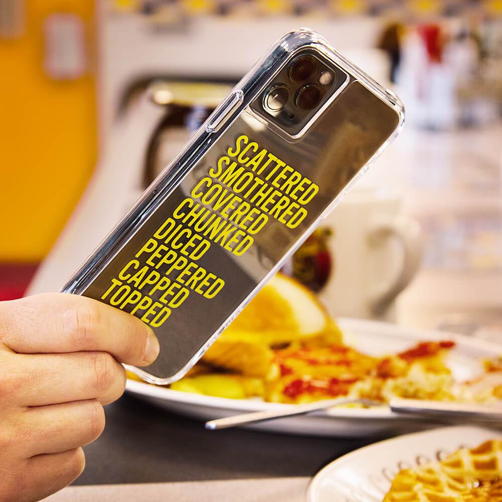 Hand holding waffle house case. color::Hashbrowns Clear