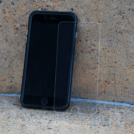 Glass Screen Protector  propped up against iPhone. color::Clear