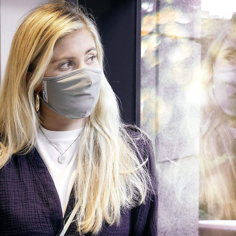 Woman wearing comfortable and effective cloth face mask. color::Grey
