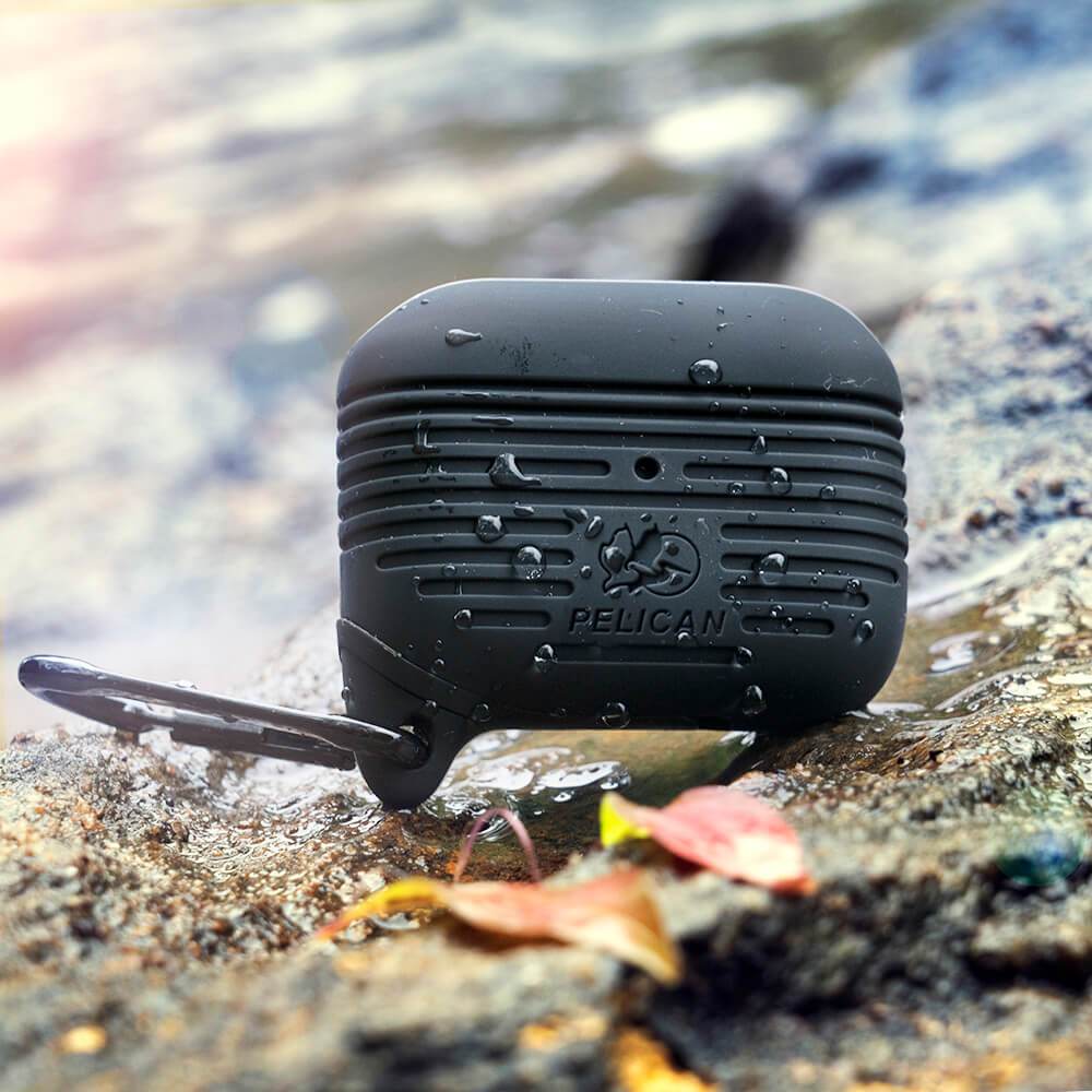 Pelican AirPod 3 Case on a rock covered in water. color::Black