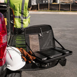 Black laptop sleeve with mesh storage compartments, open on vehicle hitch, containing laptop and accessories.