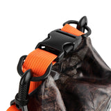 Hunter camo dry bag with orange straps and black plastic hardware for carrying.